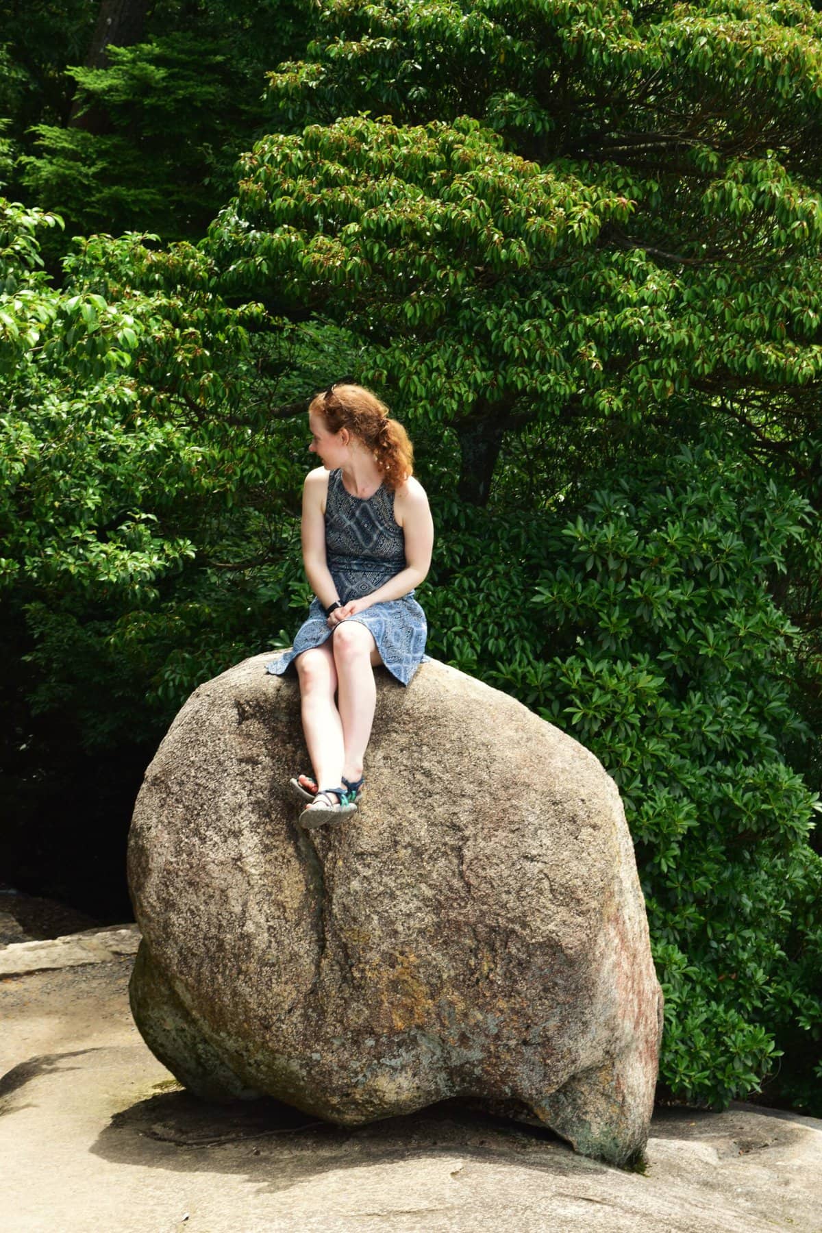 Sitting on a boulder while hiking at Miyajima