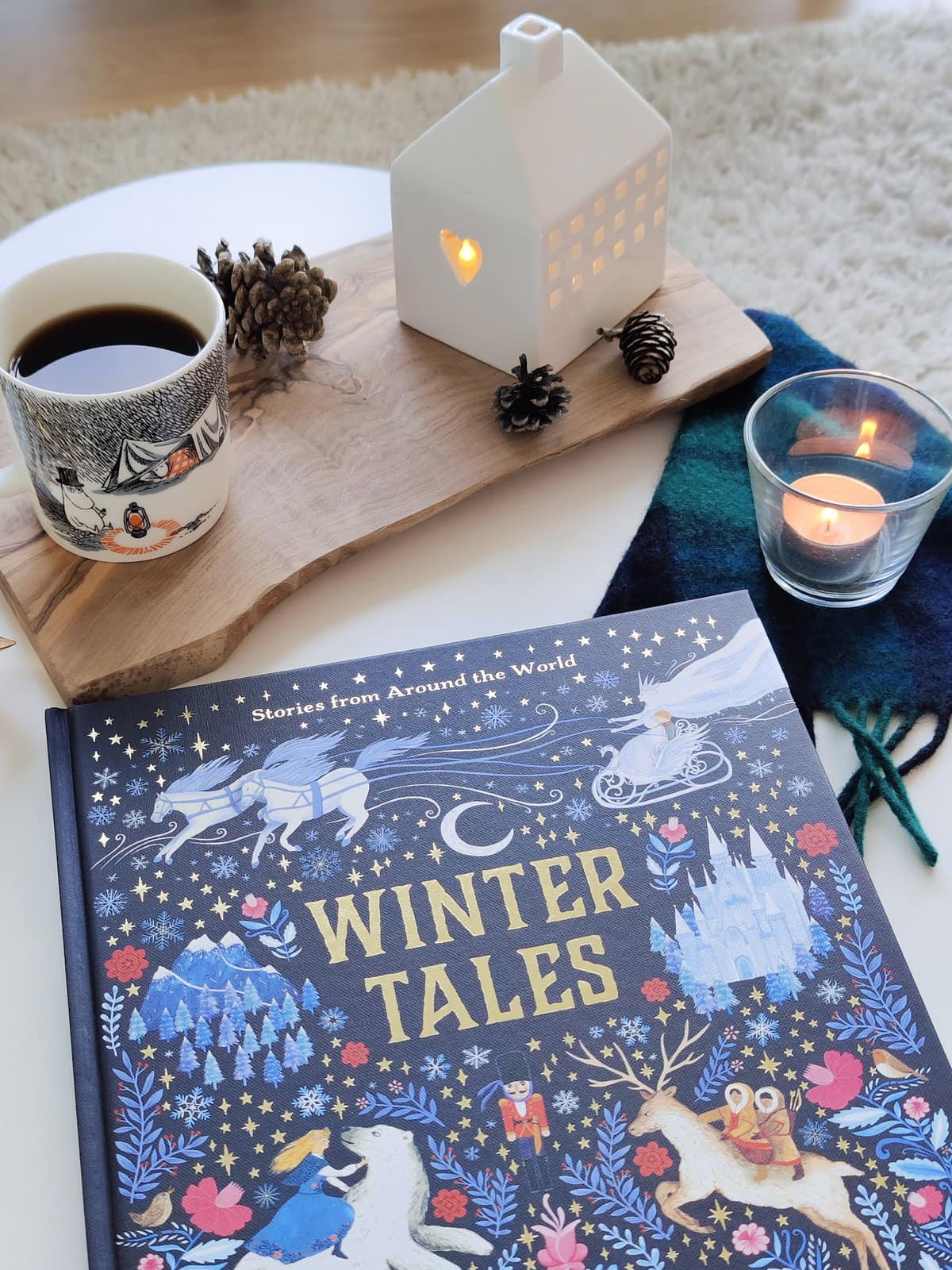 winter tales by dawn casey and zanna goldhawk in cozy setting with coffee and candles